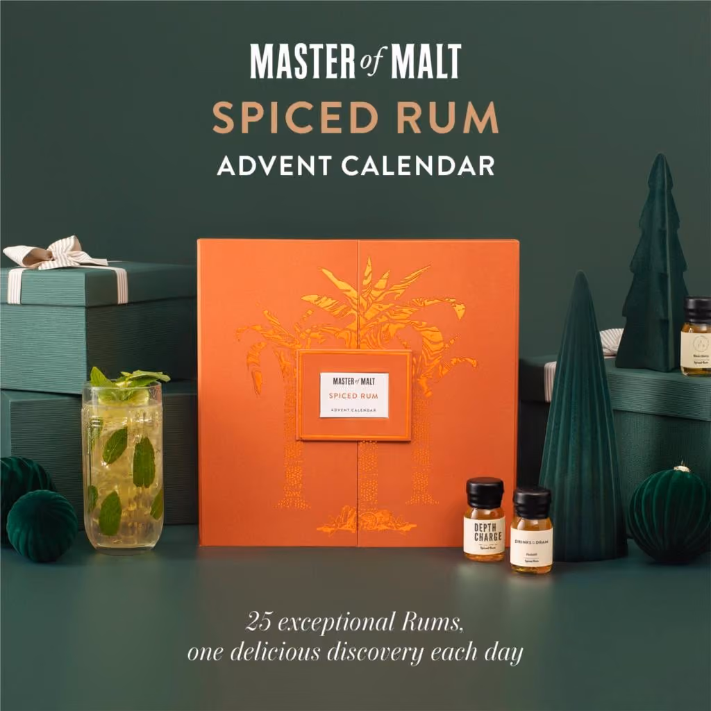The orange box on a green set with a rum cocktail and two drams