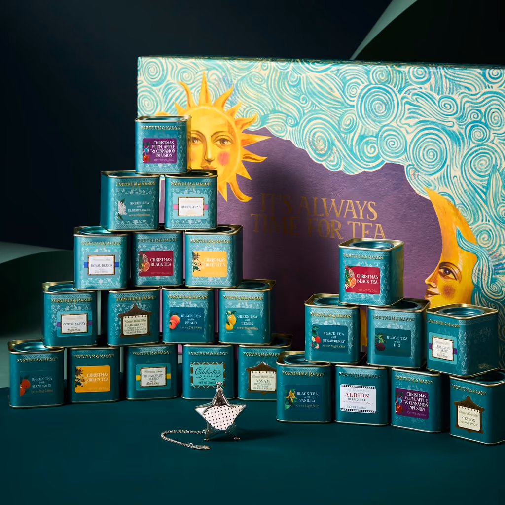 The 23 tea caddies stacked in front of the box with the star infuser
