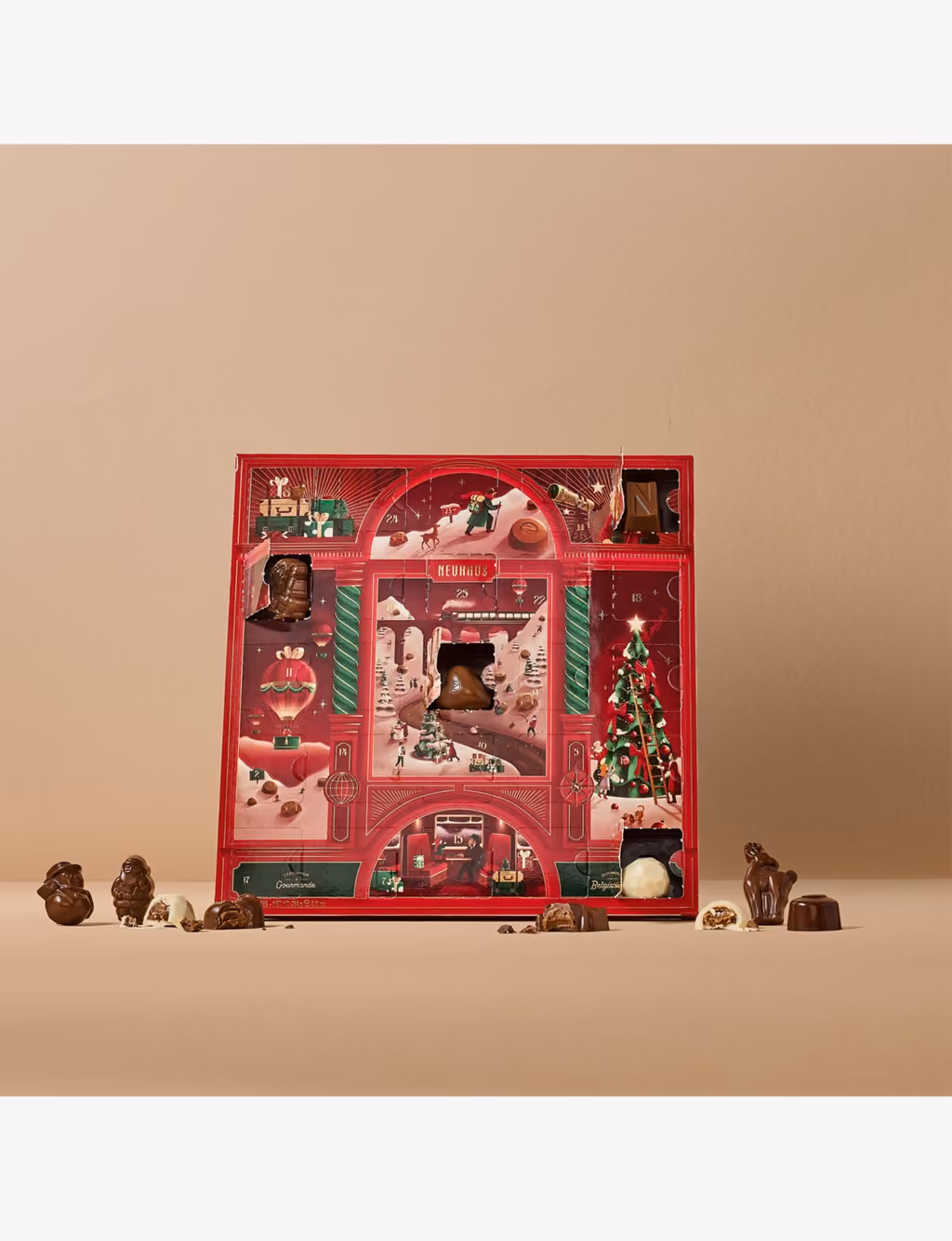 The calendar standing on a beige ground with a few windows open and chocolate figurines in front