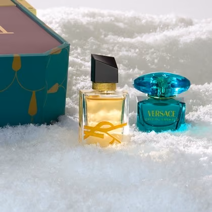 A Libre mini and a green Versace mini in snow beside the box