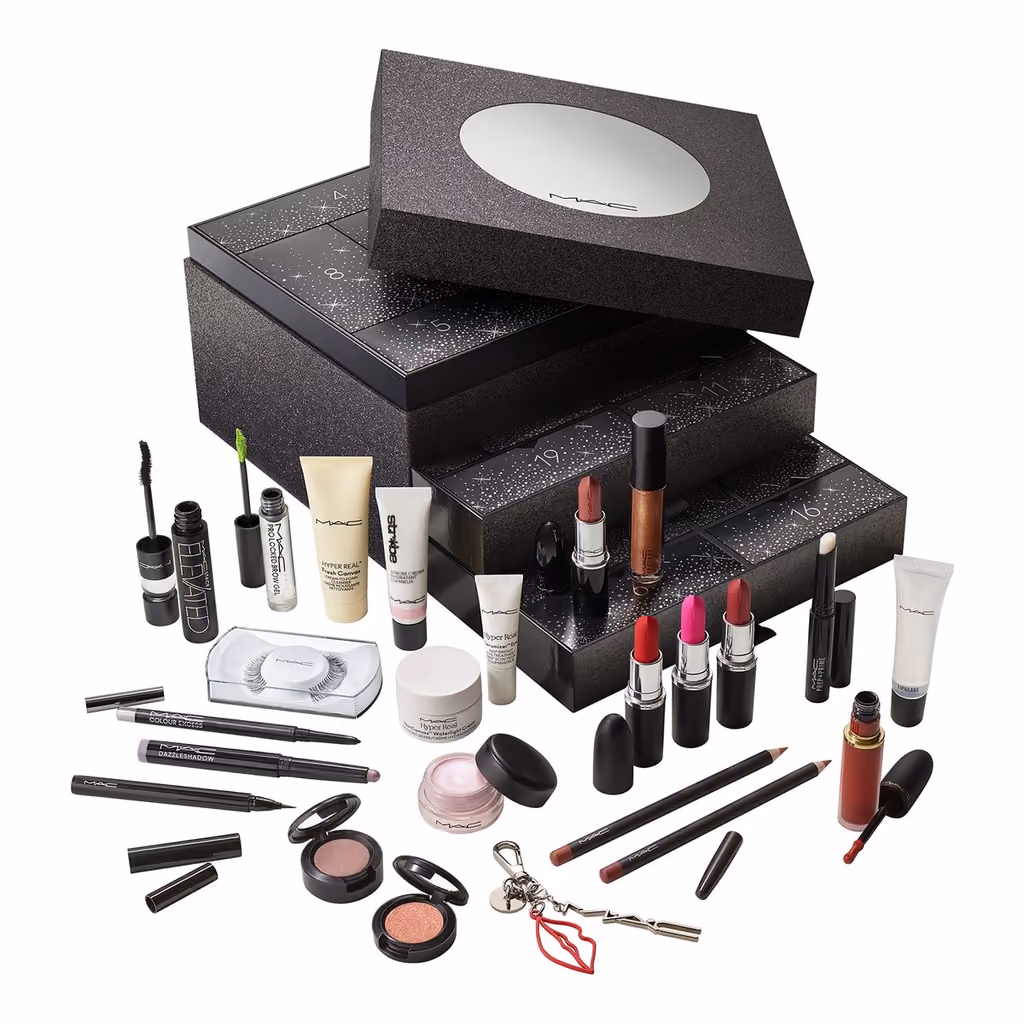 The black glitter box with its lid lifted and drawers pulled out, the products arranged in front