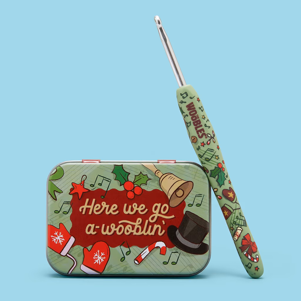 The collector's crochet hook and the Here We Go A-Wooblin' tin