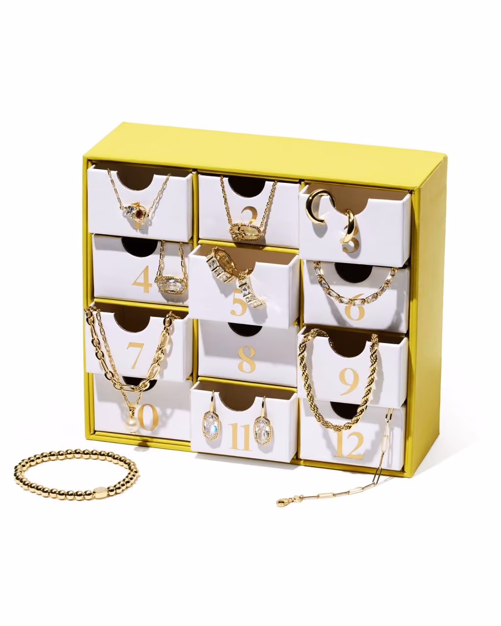 The twelve drawers pulled open with the gold jewellery hanging out