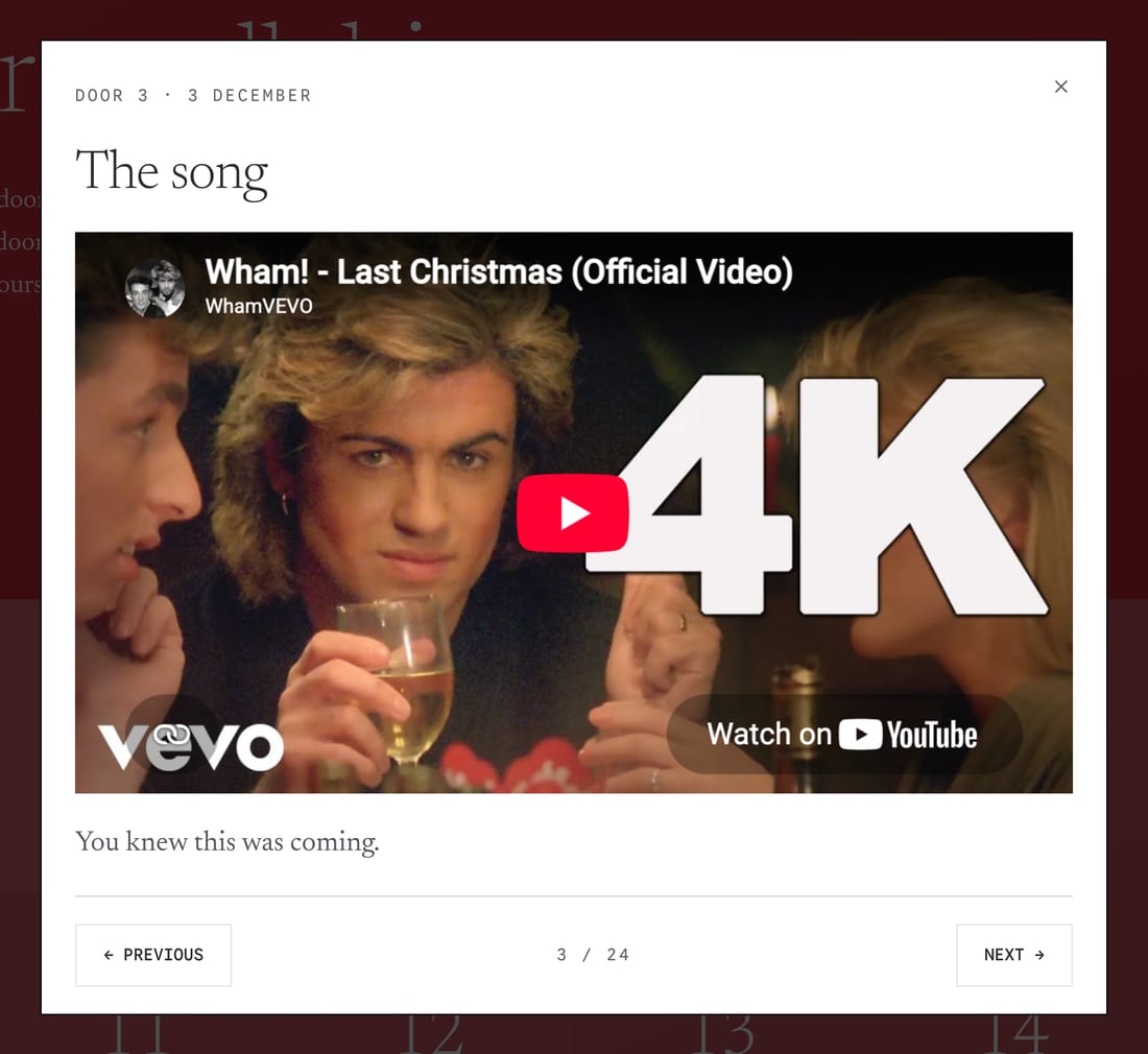 Door three of the example calendar standing open, with a YouTube video playing behind it